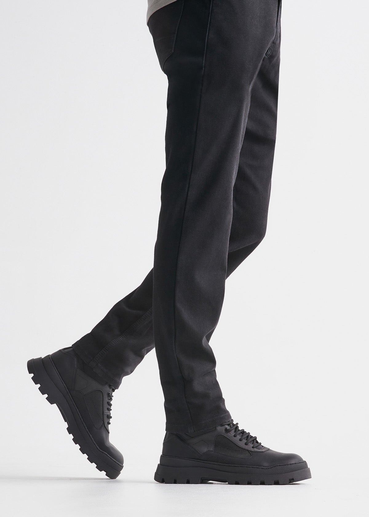man wearing black slim fit waterproof stretch jeans side