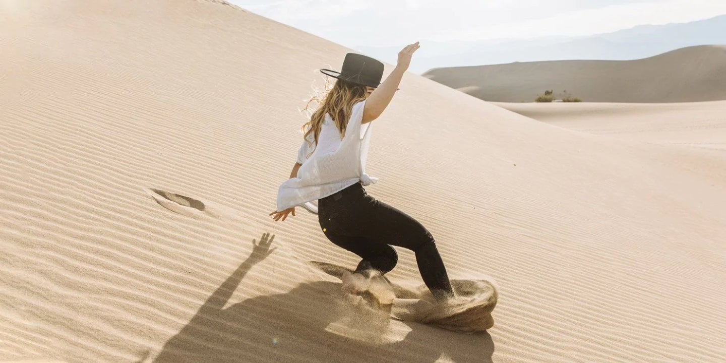 A DUER sliding down a sand dune