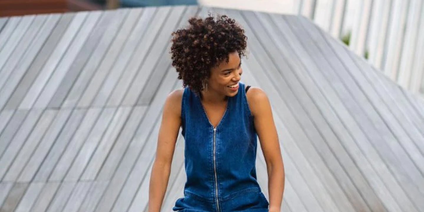 woman wearing a DUER jean jumpsuit