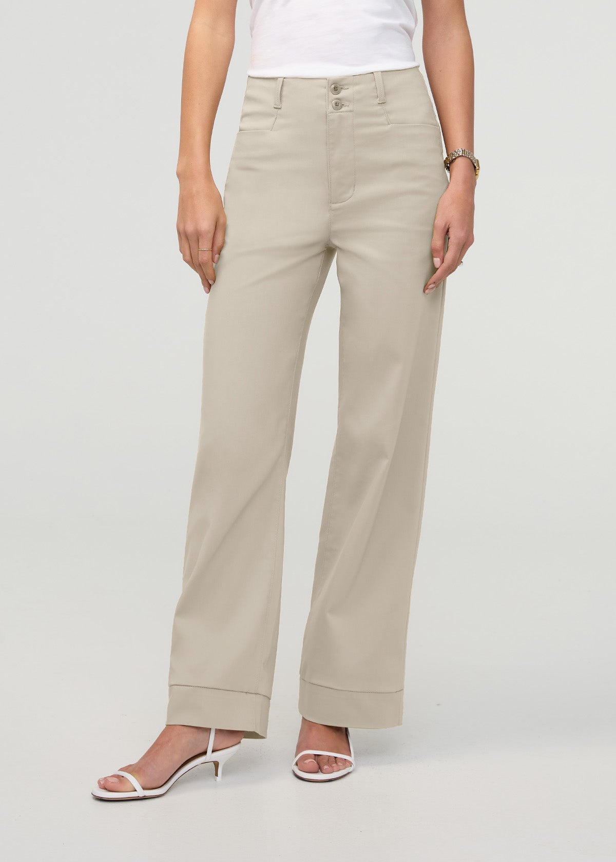 Sandstone high-rise trouser with straight legs and cuffed hem, worn with white top and sandals.