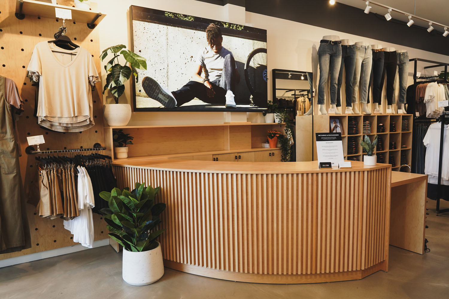 Clothing store with a wooden counter and a tv