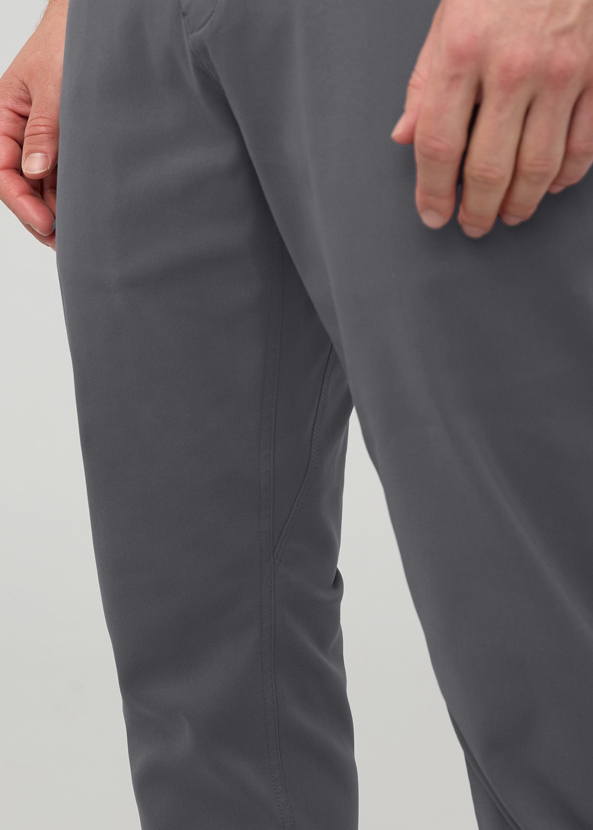 Gray relaxed taper trousers with tapered ankle, shown from waist to knee on model wearing the pants.