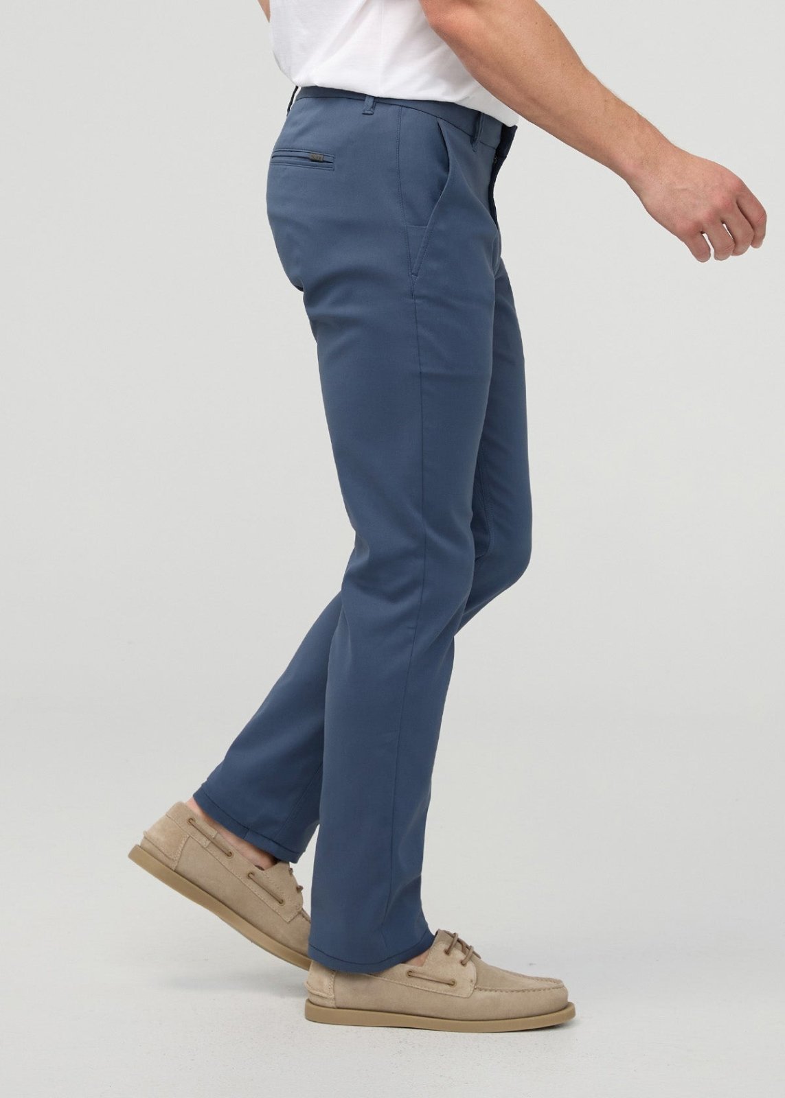 Heritage blue slim straight trousers with flat front and side pockets, worn with white shirt and tan shoes.