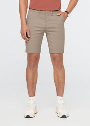 Sandstone chino shorts with front pockets and flat front waistband on male model.