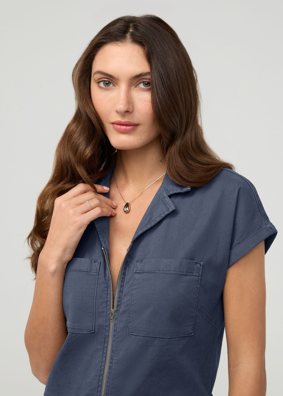 Heritage blue boiler suit with short sleeves, front zip closure, and chest pockets worn by model.