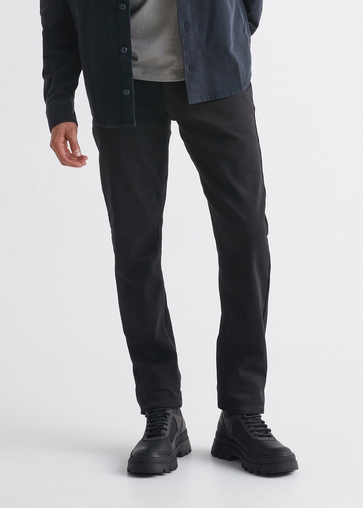 man wearing black slim fit waterproof stretch jeans front