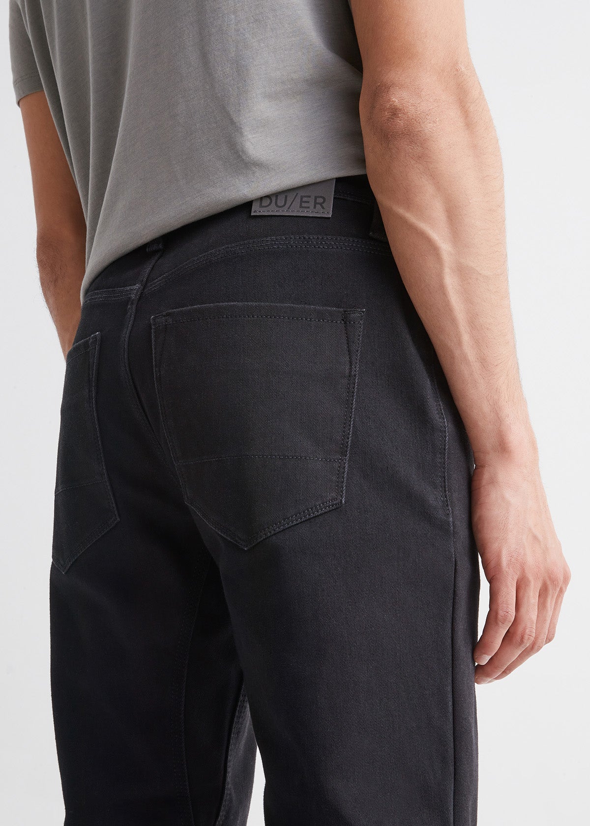 man wearing black slim fit waterproof stretch jeans back patch detail