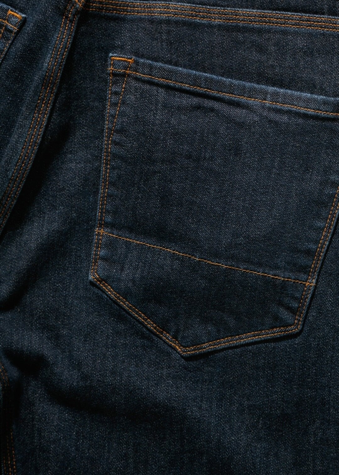 dark wash denim with accented copper stitching and trims