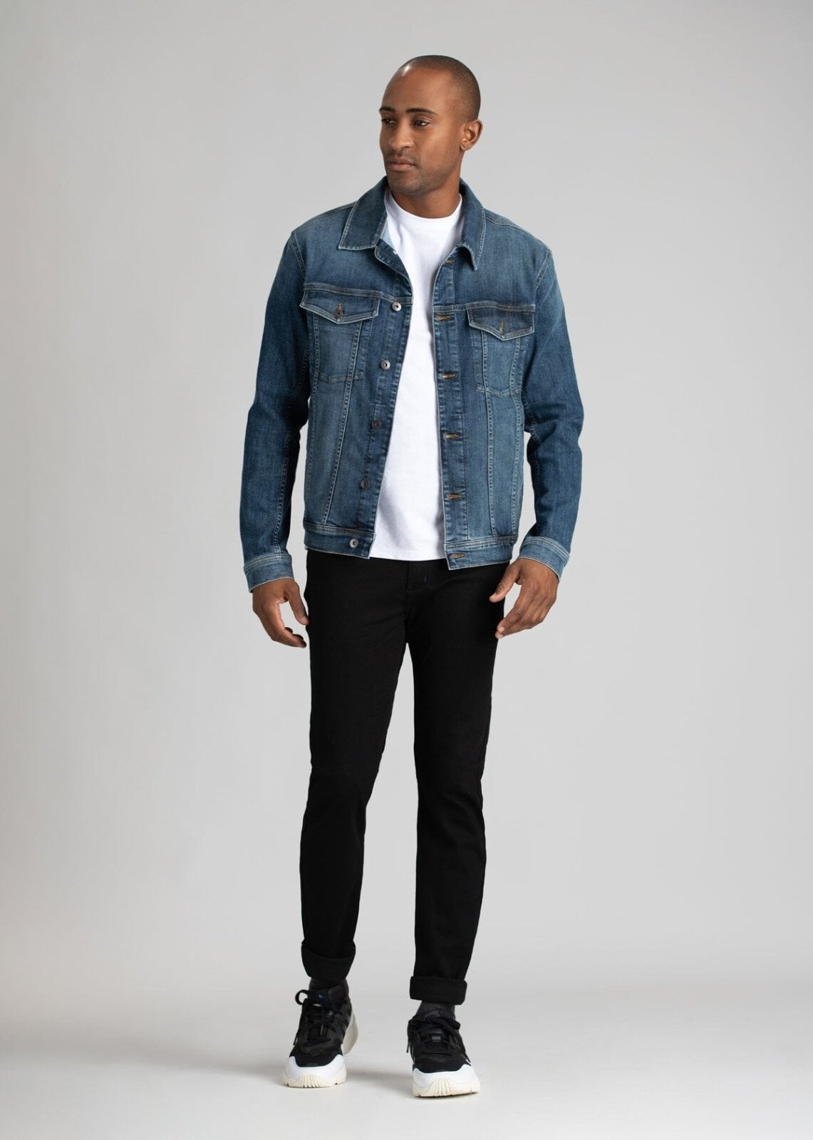man wearing water resistant stretch jeans with a denim jacket
